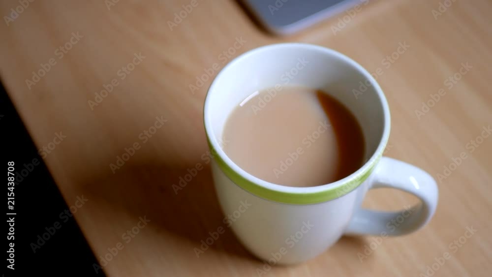 White English Breakfast Tea in a ceramic cup with green edging. White English Breakfast Tea in a ceramic cup with green edging.
