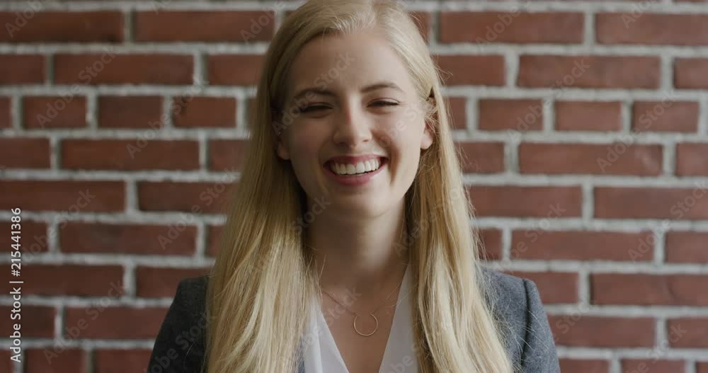 portrait beautiful young blonde business woman laughing enjoying successful independent lifestyle cheerful young female entrepreneur on brick wall background portrait beautiful young blonde business woman laughing enjoying successful independent lifestyle cheerful young female entrepreneur on brick wall background