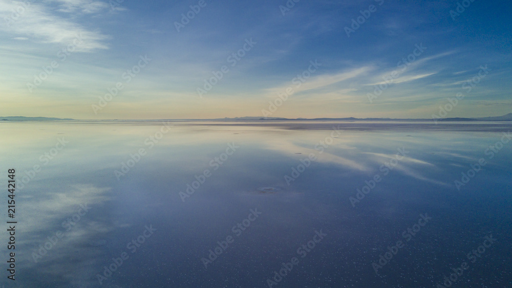 Aerial Uyuni reflections are one of the most amazing things that a photographer can see. Here we can see how the sunrise over an infinite horizon with the Uyuni salt flats making a wonderful mirror. 