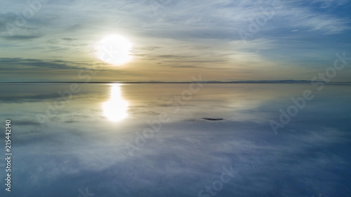 Aerial Uyuni reflections are one of the most amazing things that a photographer can see. Here we can see how the sunrise over an infinite horizon with the Uyuni salt flats making a wonderful mirror. 