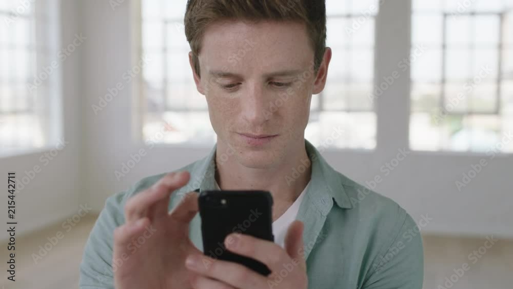 close up portrait of young red head man texting browsing using smartphone mobile technology smiling enjoying social media communication close up portrait of young red head man texting browsing using smartphone mobile technology smiling enjoying social media communication