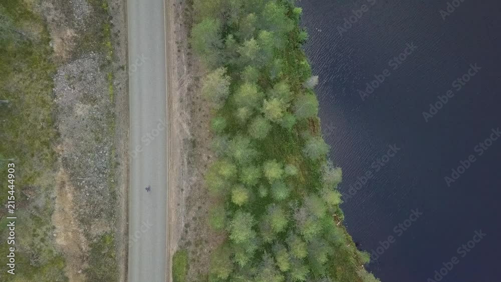 Young man longboarding empty street in Lapland. Aerial footage from above. Young man longboarding empty street in Lapland. Aerial footage from above.