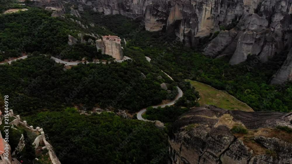 An astonishing aerial shot showcasing hundreds of years old greek monasteries on top of enormous rock formations, the Meteoras. An astonishing aerial shot showcasing hundreds of years old greek monasteries on top of enormous rock formations, the Meteoras.