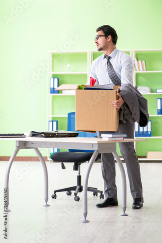 Male employee collecting his stuff after redundancy