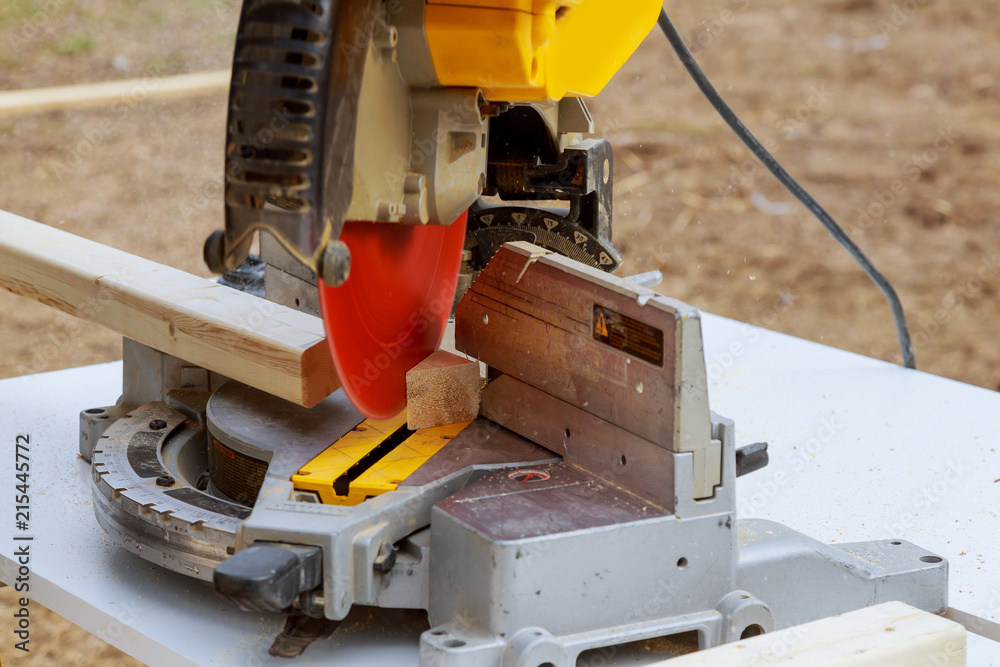 Construction worker remodeling home Carpenter cutting wooden trim board on with circular saw.