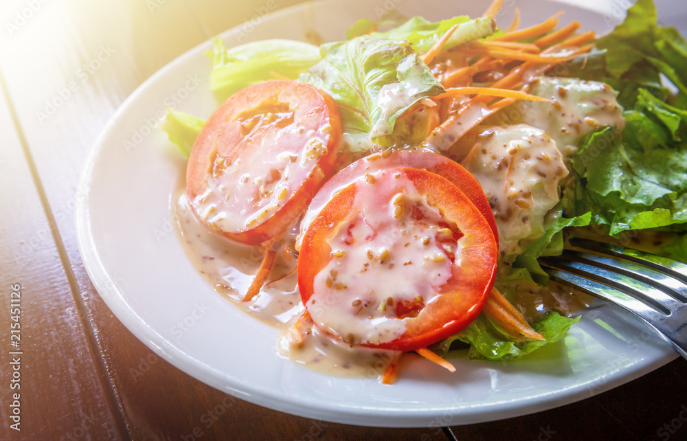 Fresh salad with sesame dressing without meat on white ceramic dish. Fresh salad with sesame dressing without meat on white ceramic dish.