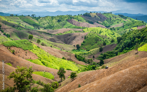 Dry mountain range remain less area of green tree inside Ampur Bo Kluea at Nan province of Thailand. Forest destoyed by agriculture of shifting cultivation.