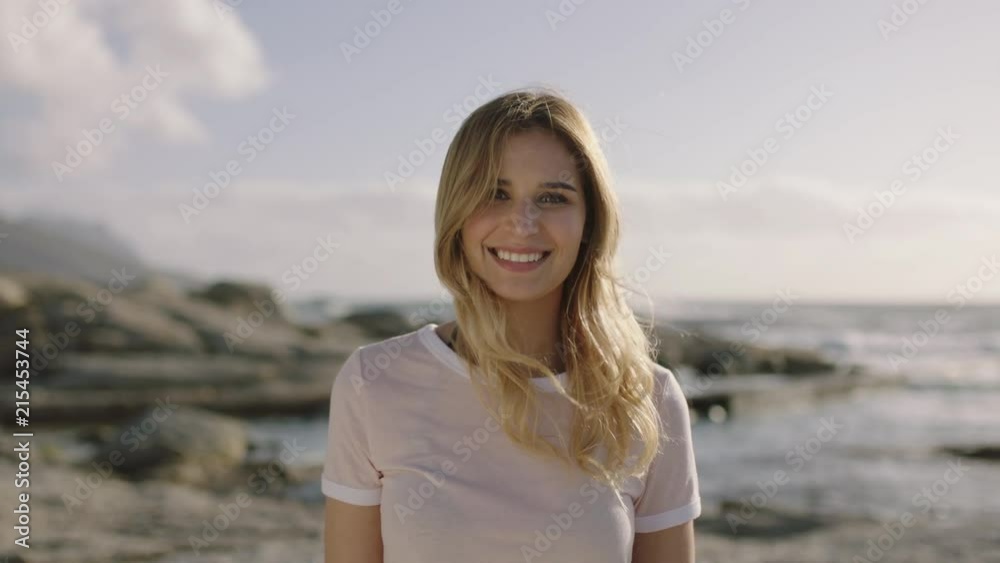 portrait of beautiful young blonde woman smiling blissful at beach portrait of beautiful young blonde woman smiling blissful at beach