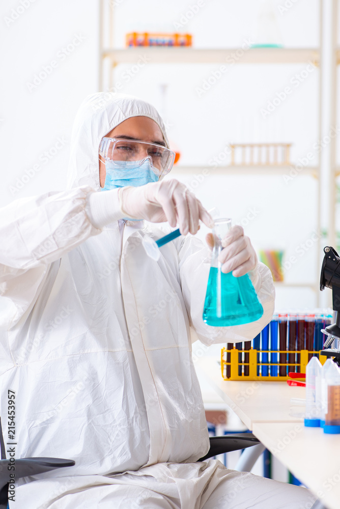 Young chemist student working in lab on chemicals Young chemist student working in lab on chemicals