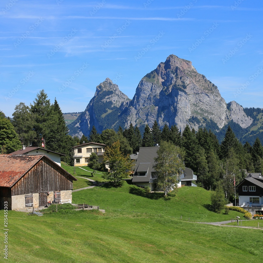 Village Stoss in summer. Mount Kleiner and Mount Grosser Mythen. Village Stoss in summer. Mount Kleiner and Mount Grosser Mythen.