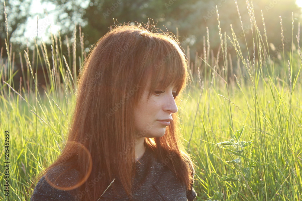 Woman portrait at sunset on the background of nature Woman portrait at sunset on the background of nature