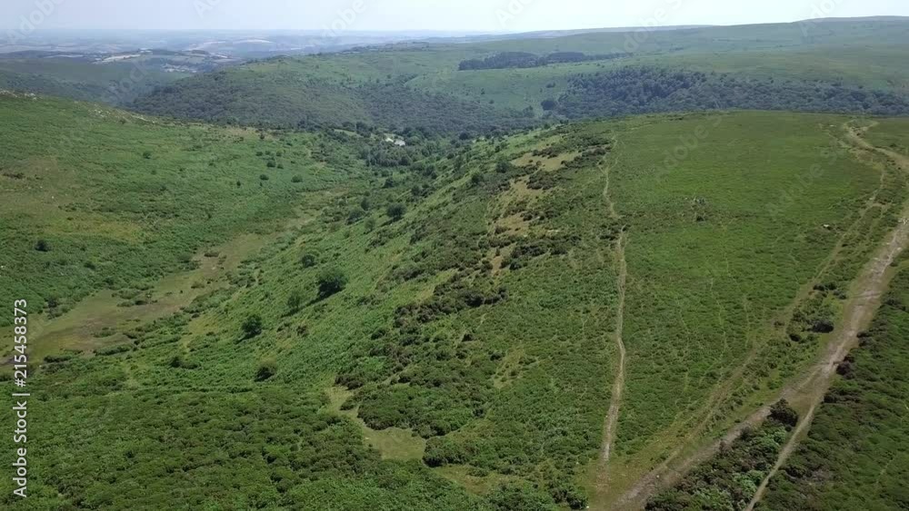 Forward tracking aerial over various wild grassy moorland in the heart of Dartmoor, Devon, England. Forward tracking aerial over various wild grassy moorland in the heart of Dartmoor, Devon, England.