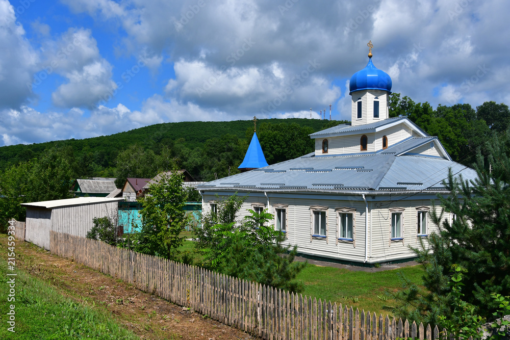 Wooden church of the Intercession of the Mother of God in the village of Anuchino in summer. Primorsky Krai, Russia
