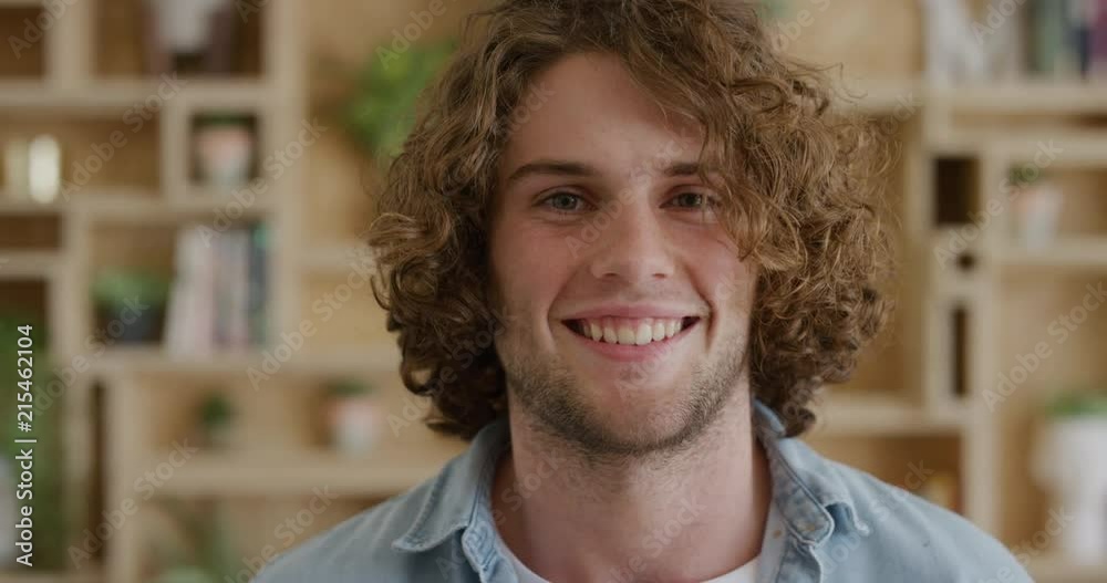 young caucasian man smiling portrait happy enjoying success satisfaction looking at camera cheerful friendly student slow motion young caucasian man smiling portrait happy enjoying success satisfaction looking at camera cheerful friendly student slow motion