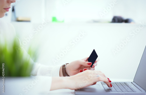 Close-up of woman s hands holding a credit card at a computer keyboard. Convenient set of funds budget wallet deposit wealth and effective investment invest resources income profit concept