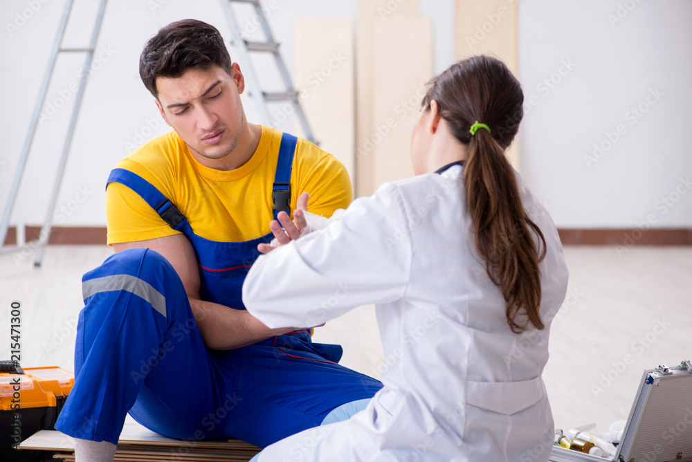 Injured worker being assisted by doctor Injured worker being assisted by doctor