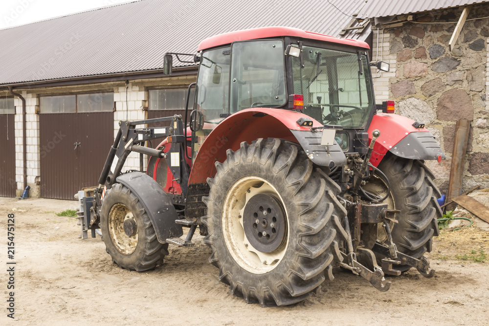 Tractor with hydraulic lift for carrying bales of hay and silage.Photo of a general view of an agricultural machine.The equipment for a dairy farm. Tractor with hydraulic lift for carrying bales of hay and silage.Photo of a general view of an agricultural machine.The equipment for a dairy farm.