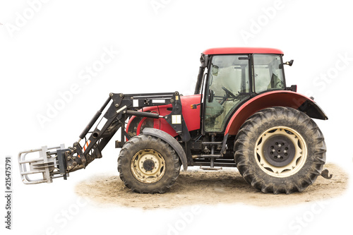 Tractor with hydraulic lift for carrying bales of hay and silage.Isolated foto of the side of the agricultural machine.The equipment for a dairy farm.