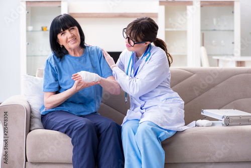 Doctor examining old mature woman after incident