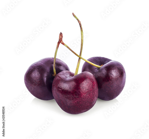 Three organic sweet cherries isolated on a white background
