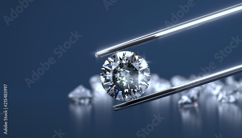 Diamond in tweezers on a bl...