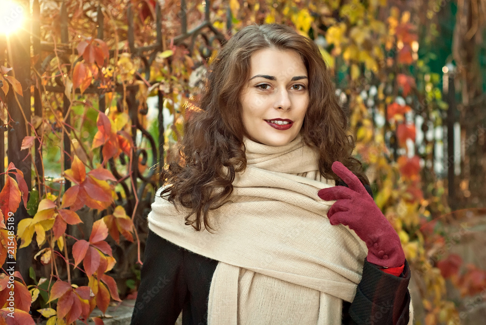 woman in a  coat walks in autumn park