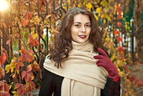 woman in a coat walks in autumn park