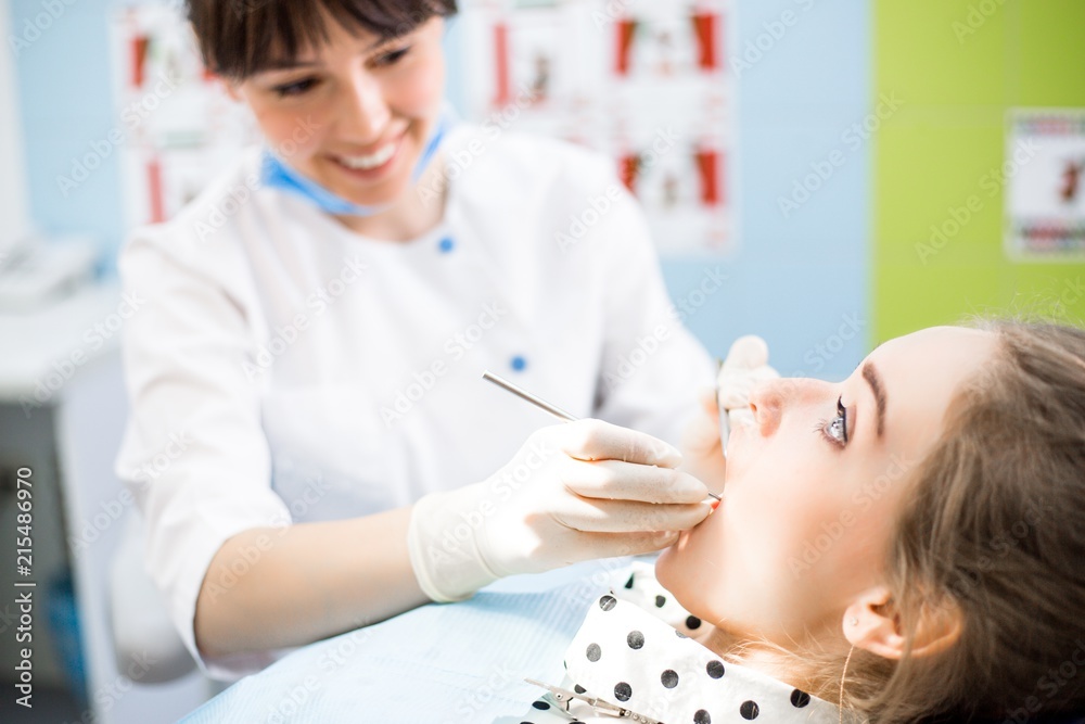 Dentist examines the oral cavity Dentist examines the oral cavity