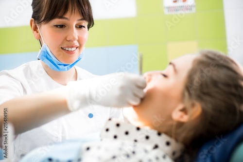 Dentist treats the teeth of the client close-up