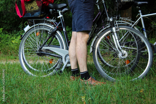 Man stands next to bicycles