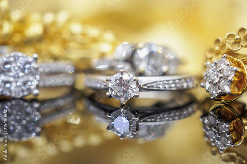 Luxury Jewelry diamond rings with reflection on black and golden background