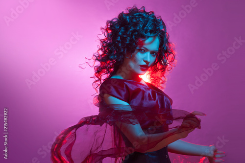 Gothic girl in red. Dancing woman with flying red dress.