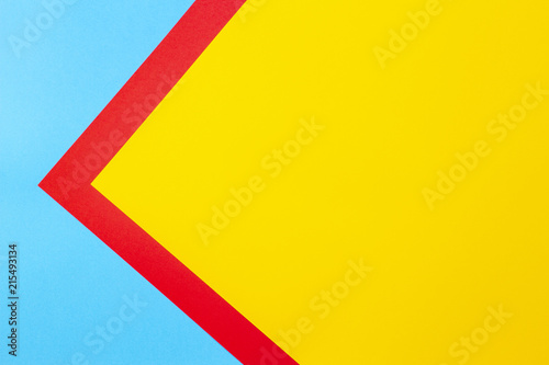Color papers geometry flat composition background with yellow red and blue tones