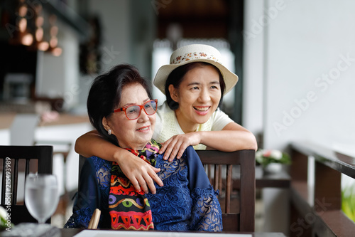 Senior asian woman with daughter relaxing on vacation together.