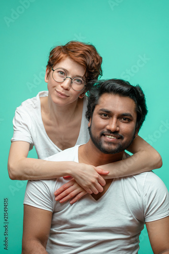 Happy attractive multiracial couple looking at the camera. love and family concept. lovers are from different contries photo