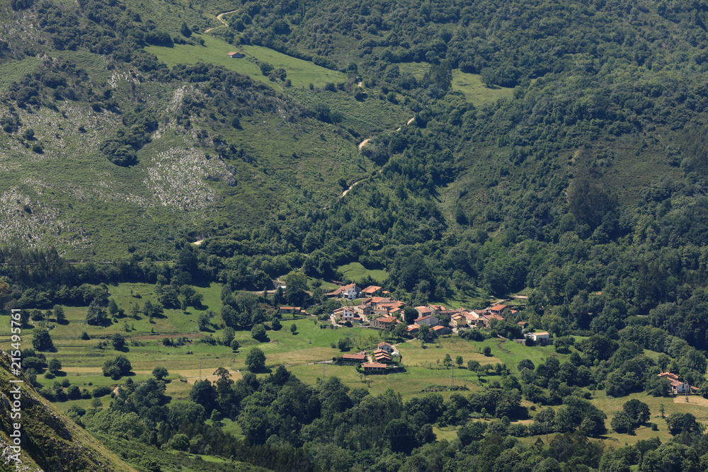 Village in a valley with green mountains