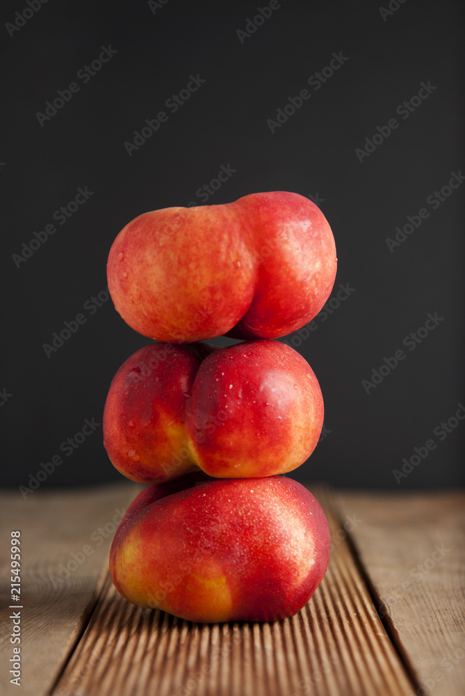 Peaches and Nectarines fruits. Concept for healthy nutrition. Dark black background and wooden table. Isolated. Peaches and Nectarines fruits. Concept for healthy nutrition. Dark black background and wooden table. Isolated.