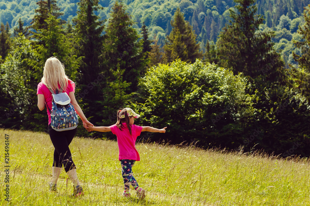 Fototapeta premium mother and little daugther hiking in mountains