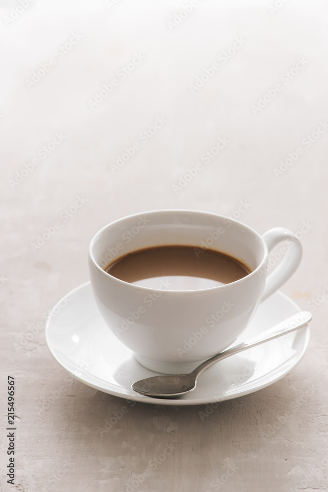 White china cup of tea with milk on a plain background