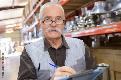 smiling worker looking at camera in warehouse