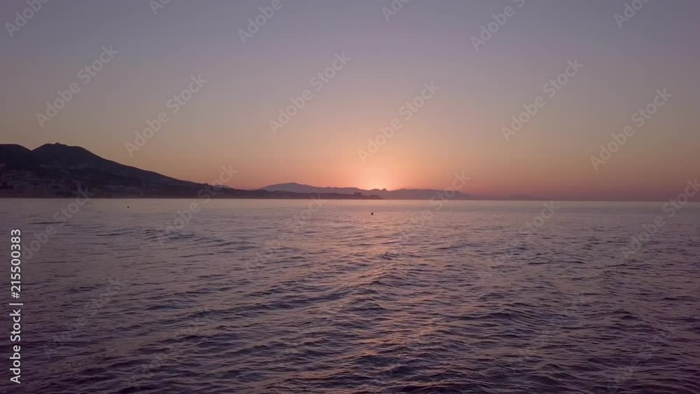 Beginning of sunrise over sea near spanish coastal city - still shot Beginning of sunrise over sea near spanish coastal city - still shot