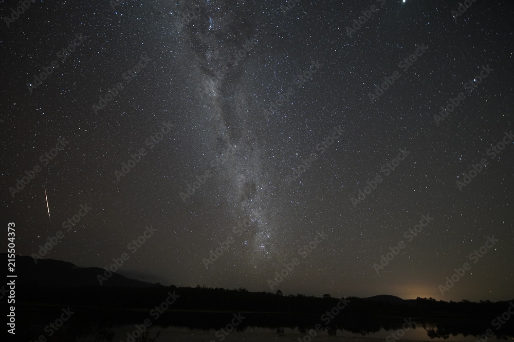 Tilted galaxy, milky way in the dark starry sky with a meteror 