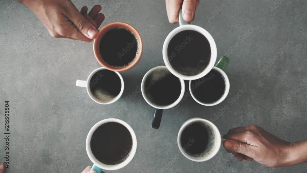 Group of friends hands holding cup of coffee
