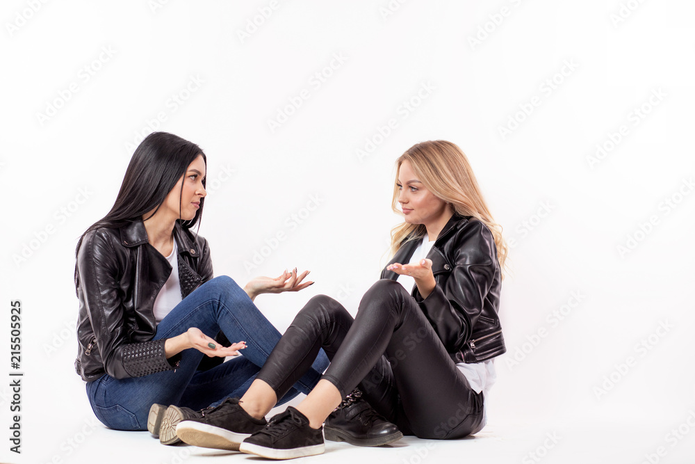 blond woman can't help her blak-haire friend in difficult situation,solve the problem , give the advise.full length photo.