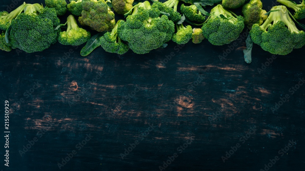Fresh green broccoli. Raw Vegetables. On a wooden background. Top view. Copy space.