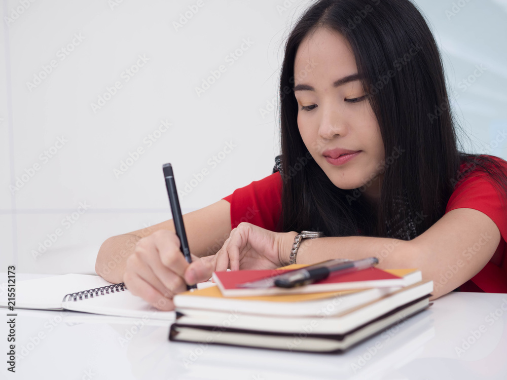 Young Asian female student with notebooks in her hands.A portrait of an Asian college student.education and learning concept. Young Asian female student with notebooks in her hands.A portrait of an Asian college student.education and learning concept.