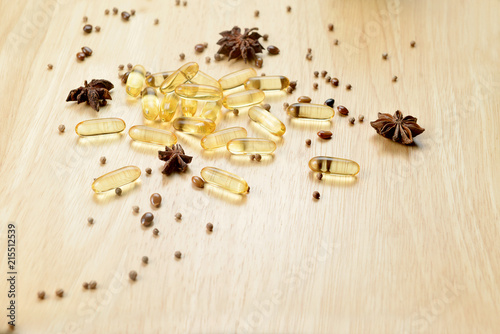 Medicine herb, Cod liver oil omega 3 gel capsules on wooden brown tone background