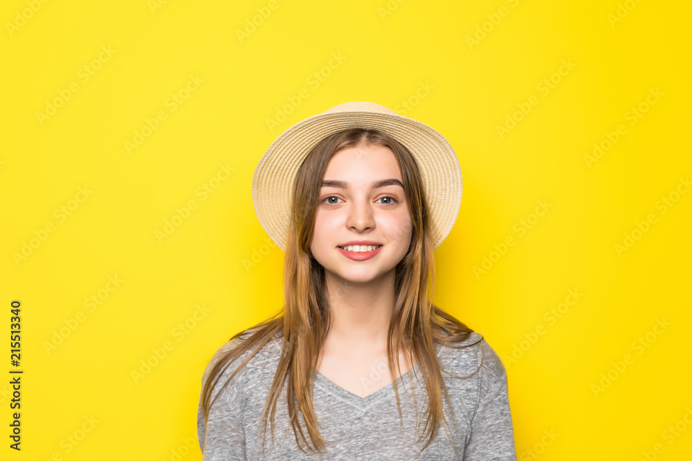 Beautiful beauty young woman in gray shirt and straw hat on yellow background. Beautiful beauty young woman in gray shirt and straw hat on yellow background.