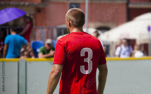 Football player on the football field with the number 3 on the T-shirt. Soccer game