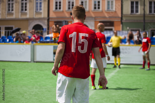 Football player on the football field with the number 15 on the T-shirt. Soccer game